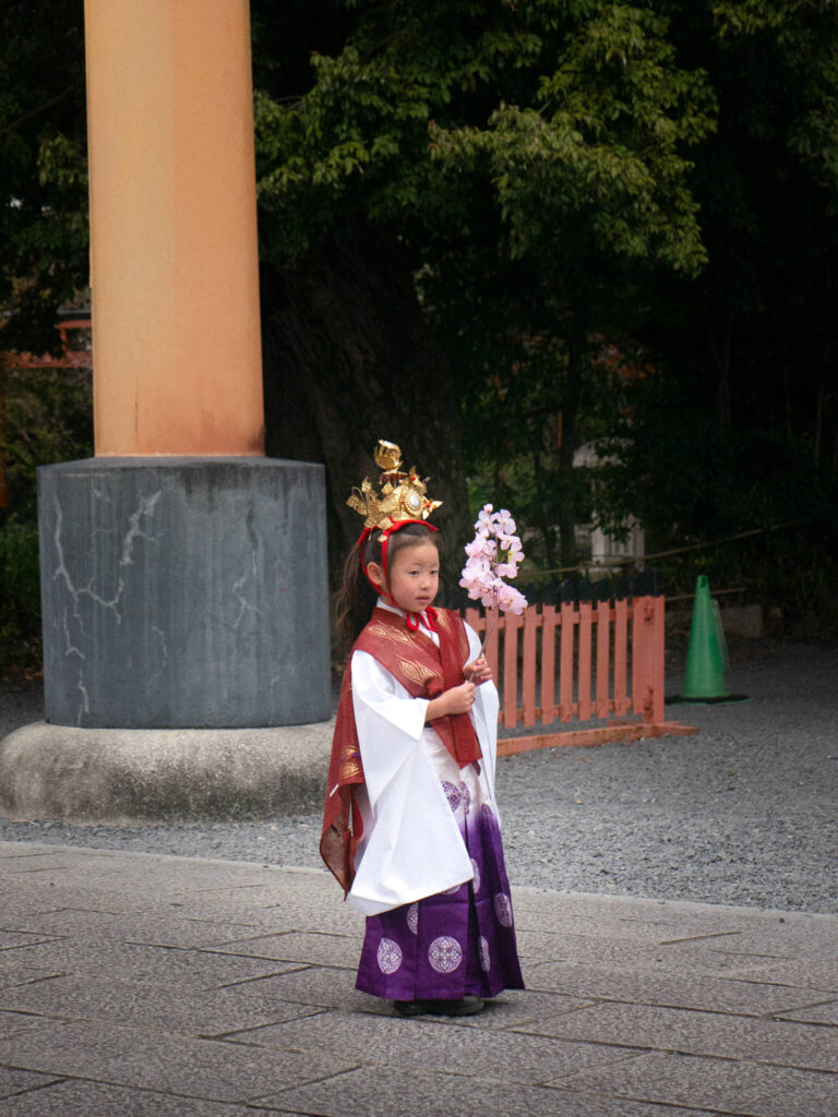 A little girl being photographed by her mother during the Sakura Festival